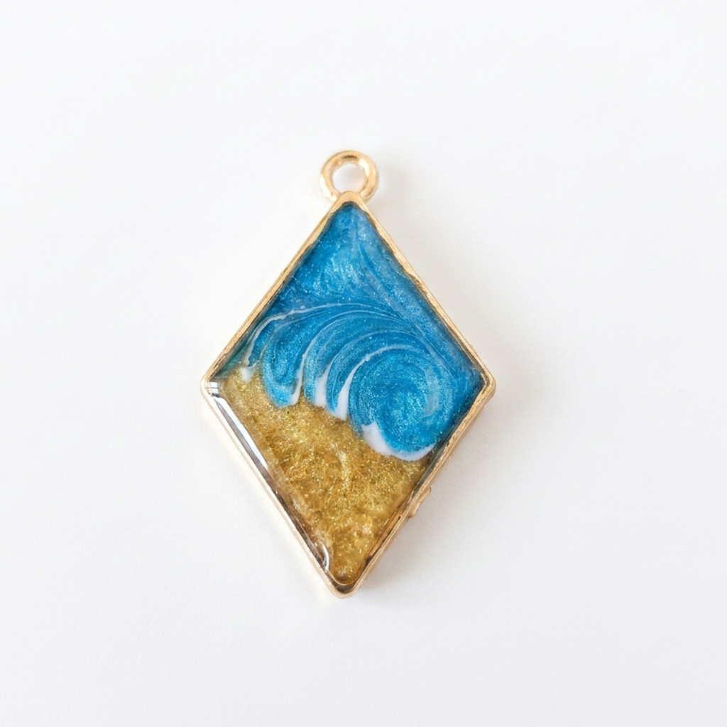 Diamond-shaped pendant with blue and gold design on a white background