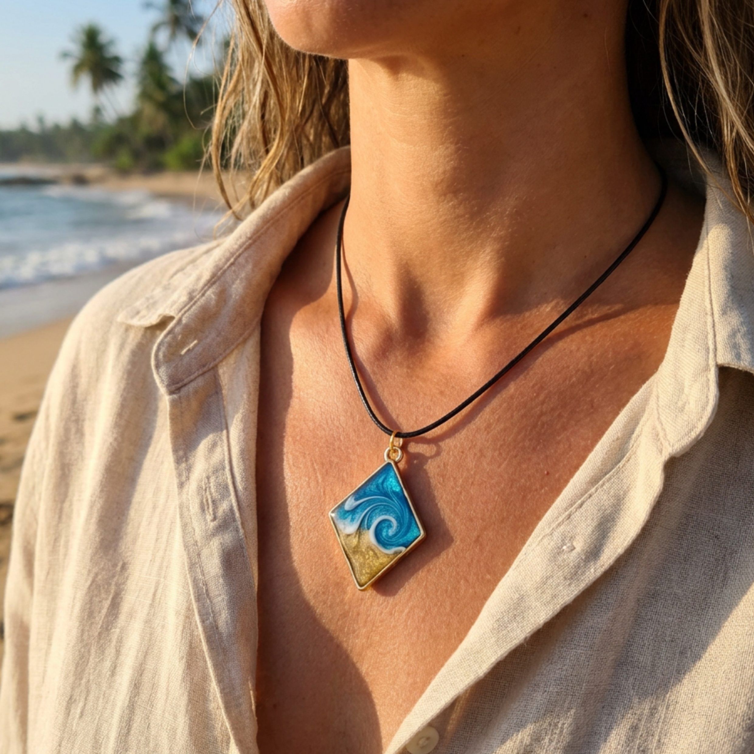 Lady wearing a diamond shaped wave pendant on a beach