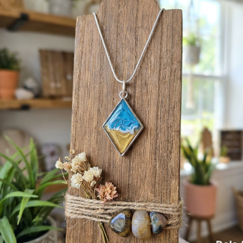 Necklace with a diamond-shaped pendant on a wooden stand with dried flowers and stones, blurred indoor background