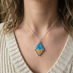 Model wearing a diamond wave pendant
