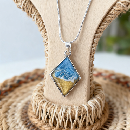 Diamond wave pendant in a silver bezel on a contemporary display stand