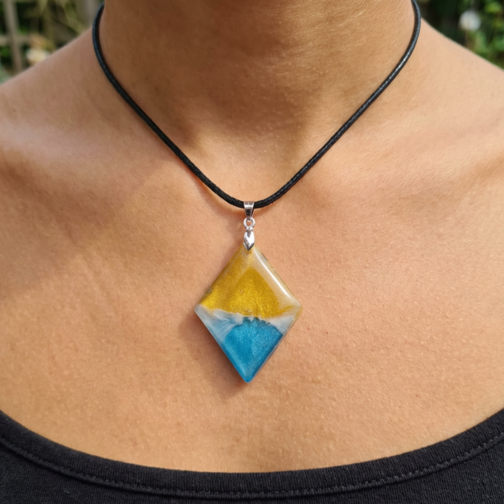 Necklace with a yellow and blue pendant on a person's neck
