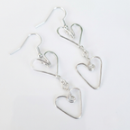 Silver heart-shaped earrings on a white background