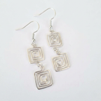 Silver square earrings on a light white background