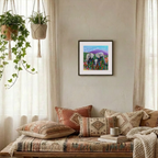 Cozy living room with a wooden bench, patterned cushions, and a framed artwork on the wall.