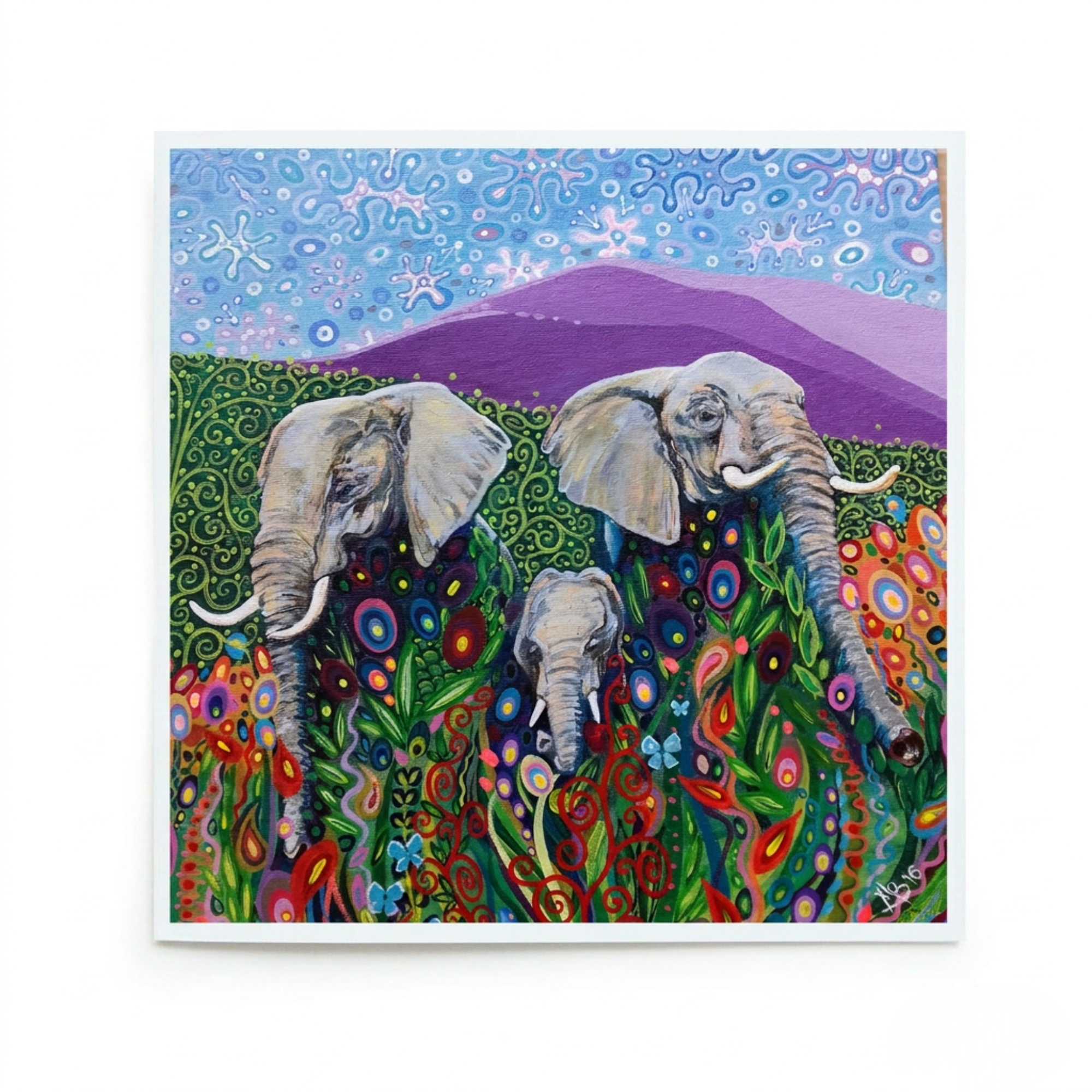 Colourful painting of three elephants in a field with flowers and mountains.