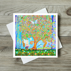 Colourful card with a tree, fairy and animals on a wooden surface