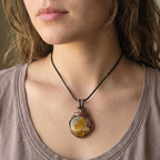 Female model wearing a tshirt and a yellow picture jasper pendant wrapped in copper wire