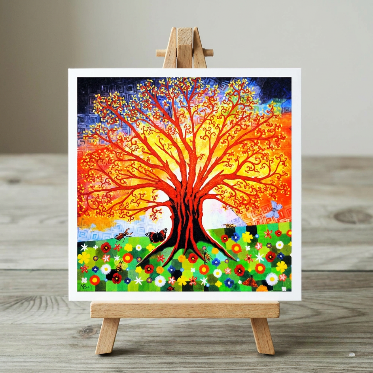 Colorful tree painting on a wooden easel against a neutral background