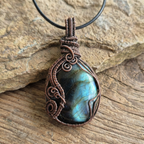 Necklace with a Labradorite pendant on a wooden surface
