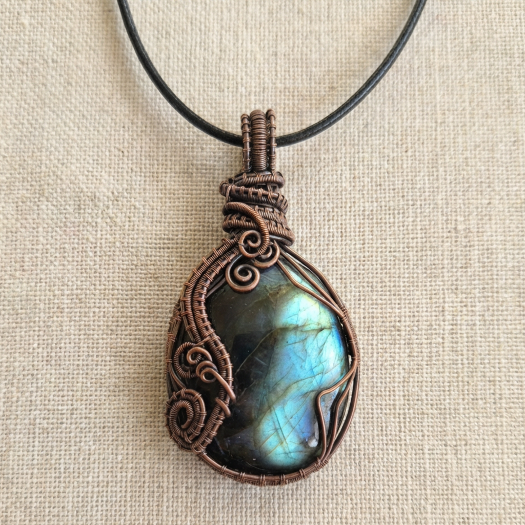 Necklace with a Labradorite stone pendant on a beige fabric background