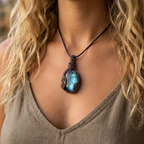 Necklace with a blue labradorite pendant worn by a person with blonde hair.