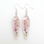 Teardrop-shaped earrings with floral design on a white background