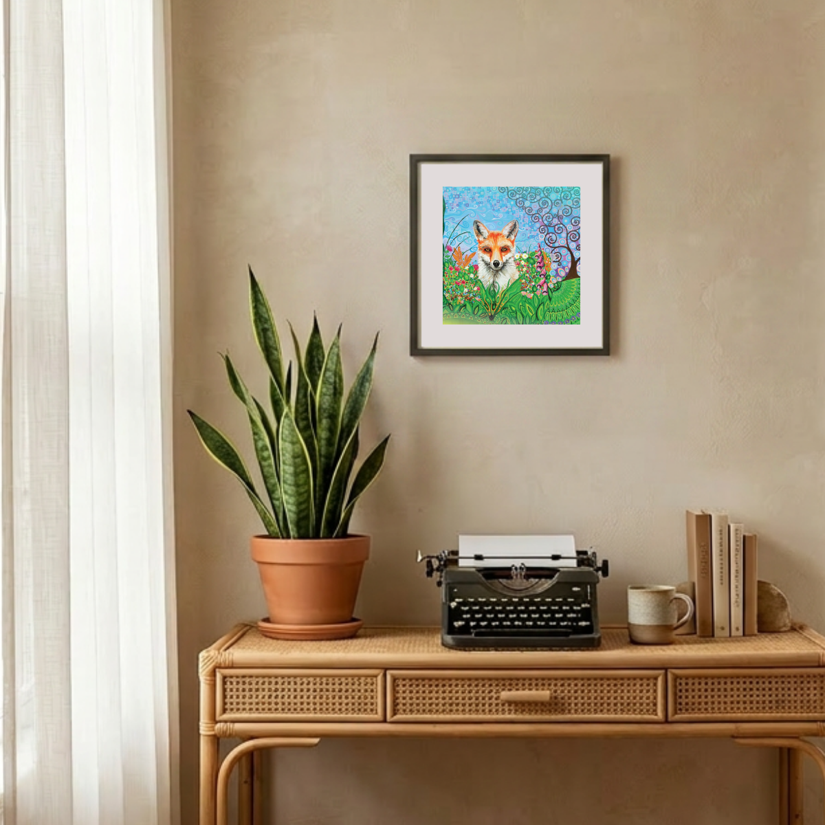 Framed artwork of a fox in a garden above a desk with a plant, typewriter, and books.