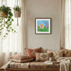 Cozy living room with a framed picture of a fox, pillows, and plants.