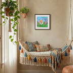Decorative indoor swing with colourful pillows and a framed picture of a fox on the wall.