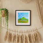 Framed abstract artwork on a wall with decorative elements