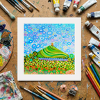 Colourful abstract painting on a wooden surface with art supplies