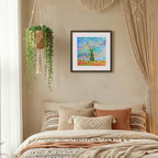Cozy bedroom with a bed, decorative pillows, hanging plant, and wall art.