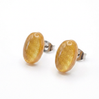 Simple gold oval stud earrings on a white background