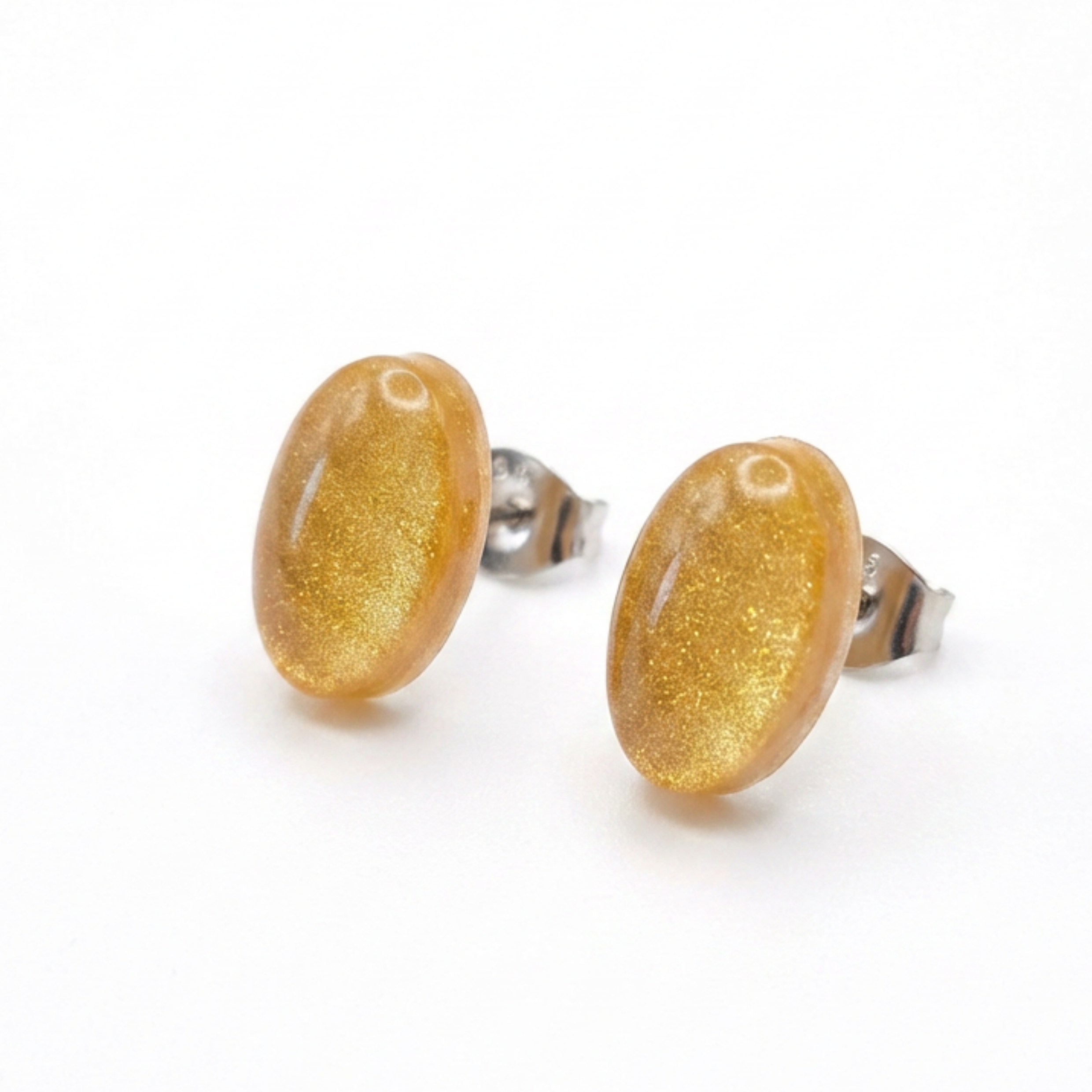 Simple gold oval stud earrings on a white background