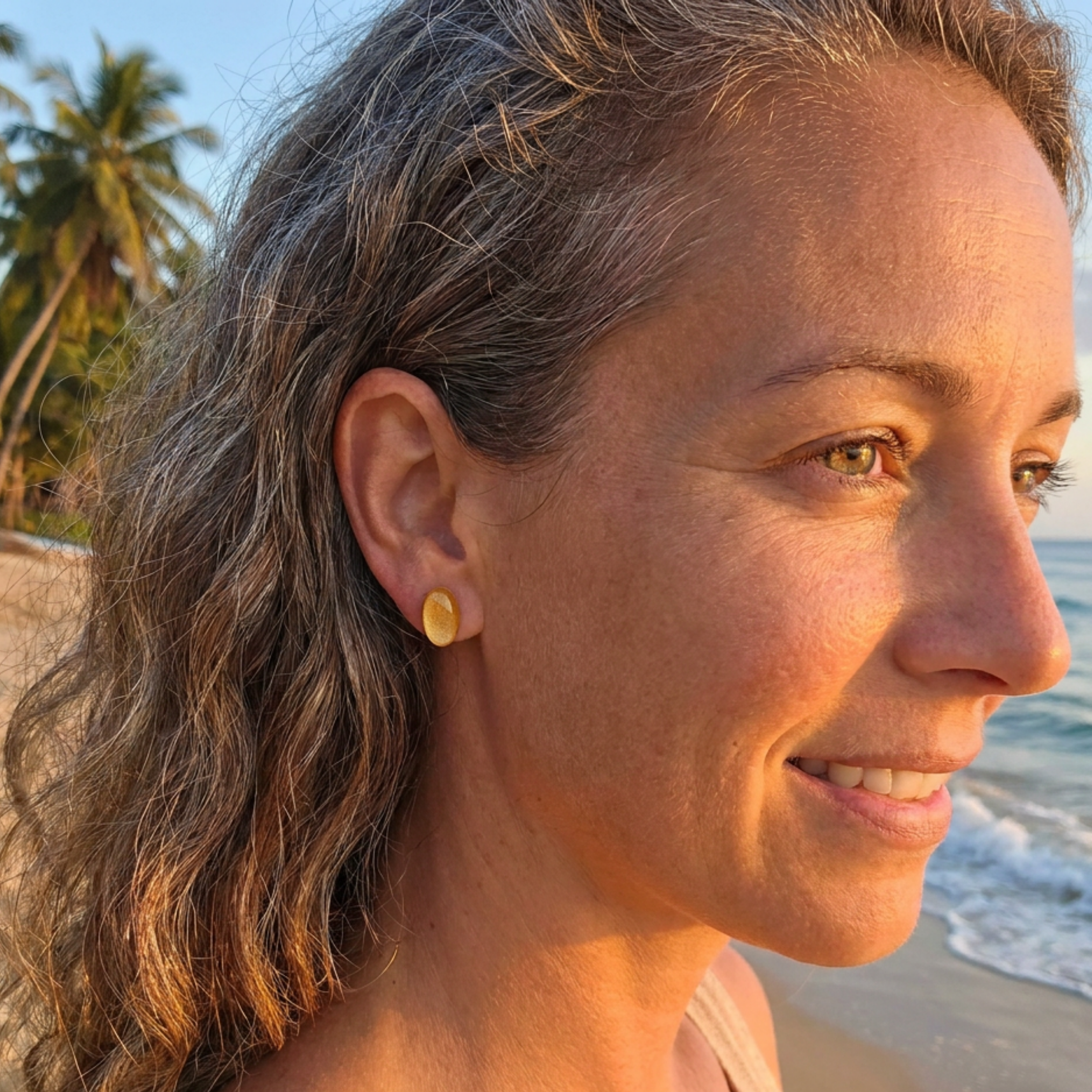 Woman with a yellow earring on a beach