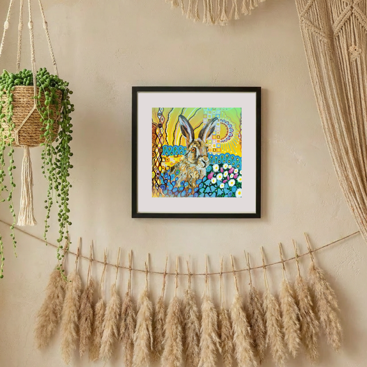 Framed artwork of a rabbit with a colourful abstract background on a wall with decorative elements.