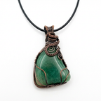 Green stone pendant with copper wire wrapping on a white background