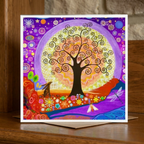Colourful greeting card with a tree of life design on a wooden surface