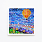 Colourful abstract artwork with a hot air balloon and circular patterns on a white background