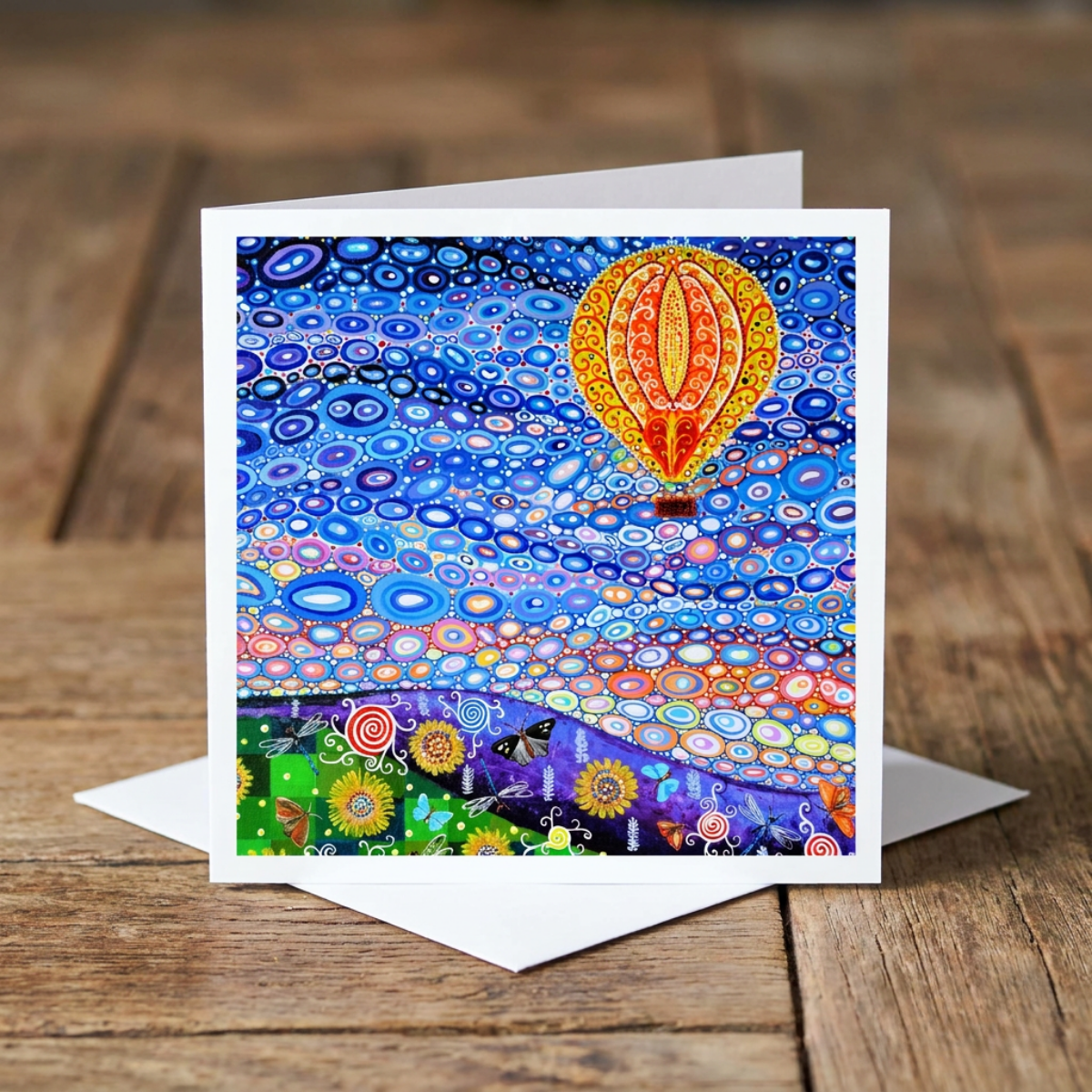 Colourful card with a hot air balloon design on a wooden surface