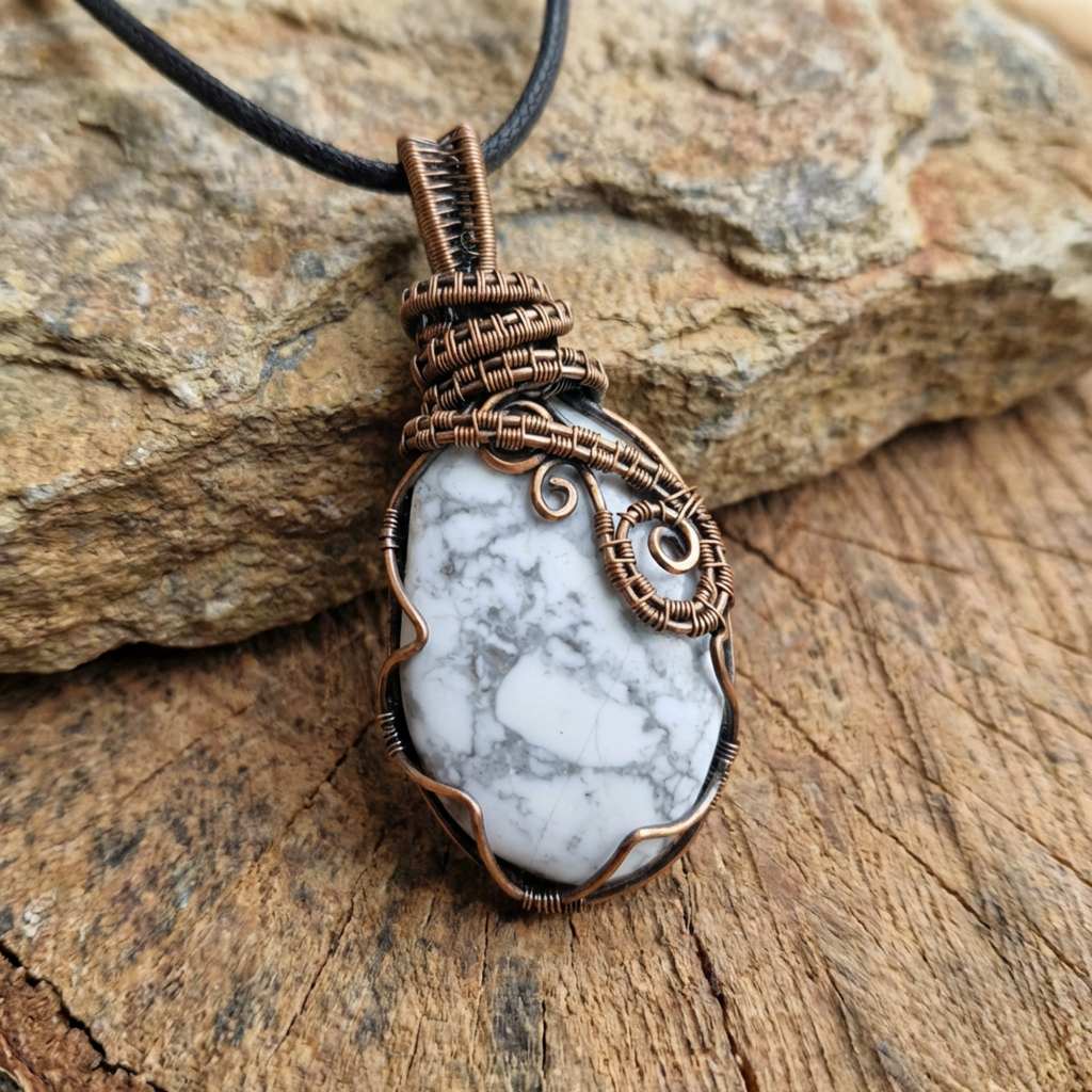 Necklace with a white howlite stone pendant on a wooden surface