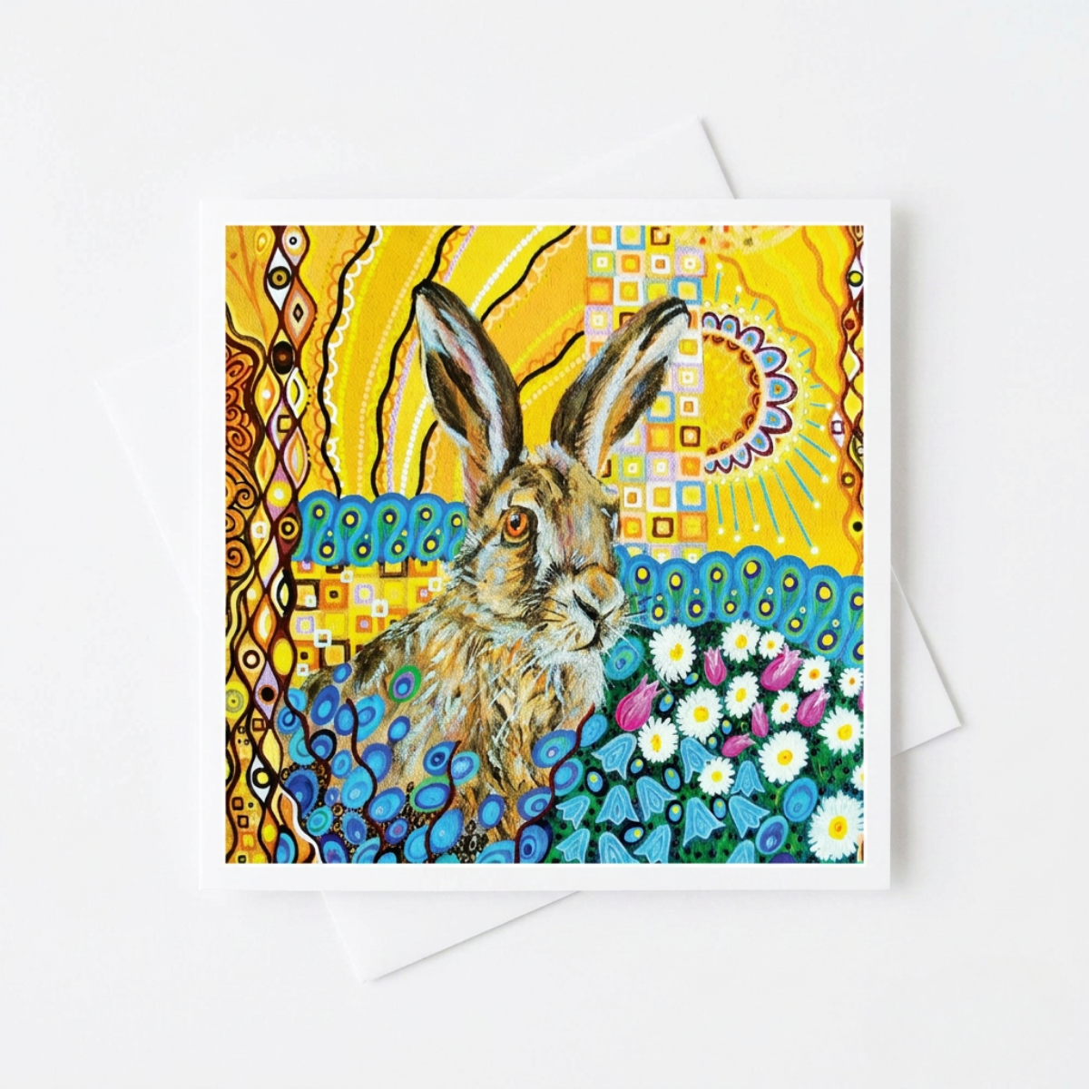 Greeting card with a colourful design featuring a hare and floral elements on a yellow background.