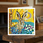 Colourful greeting card with a hare illustration on a wooden surface