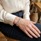 Model wearing a open silver spiral statement bracelet