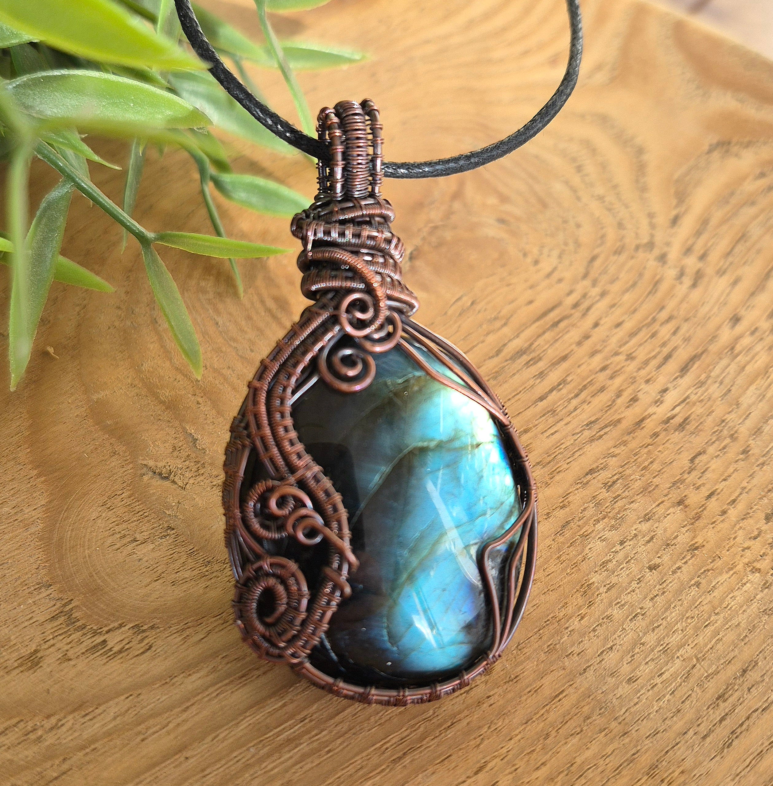 Necklace with a decorative labradorite pendant on a wooden surface