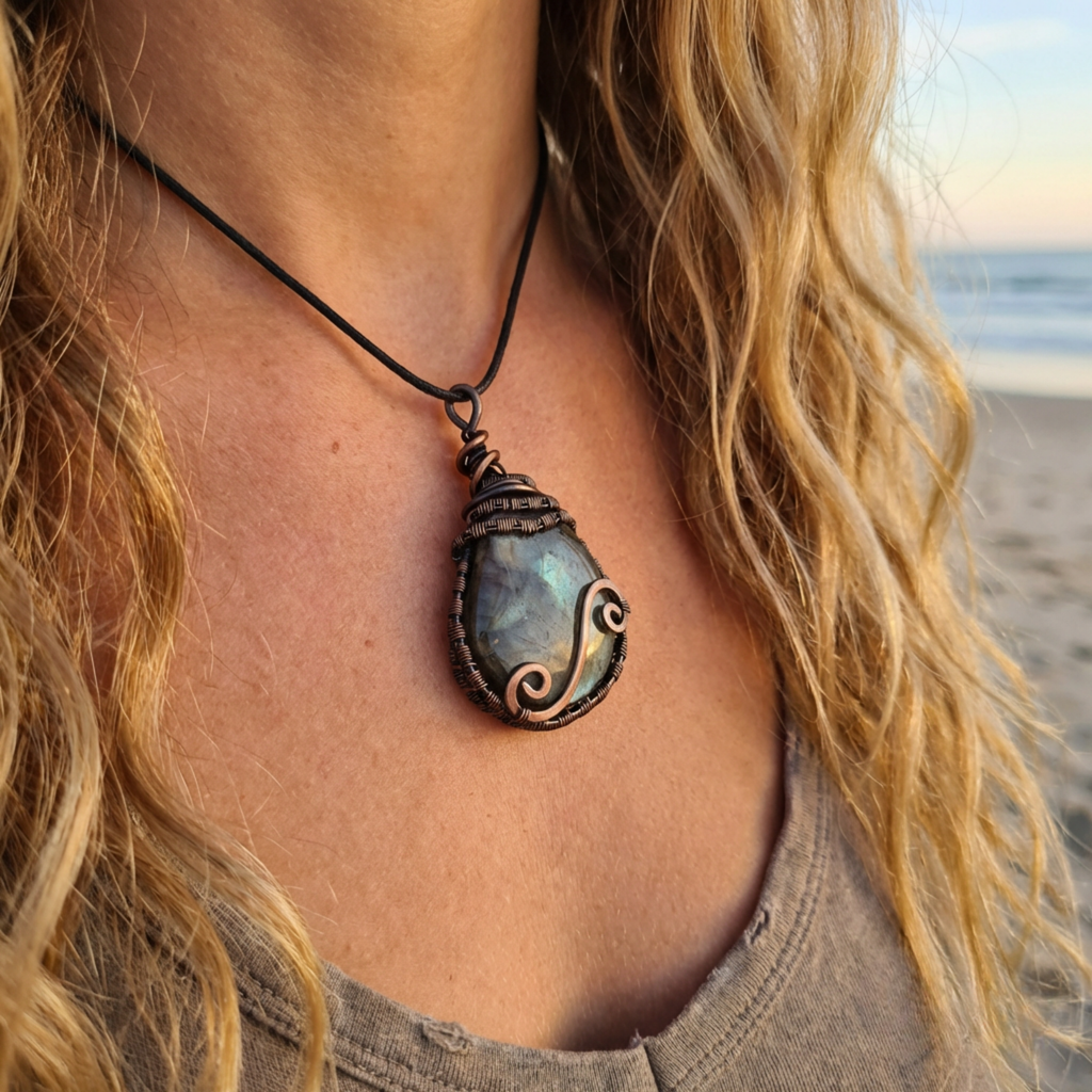 Necklace with a pendant worn by a person on a beach