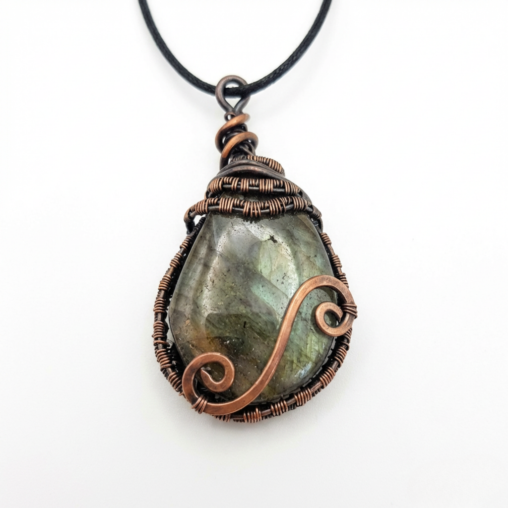 Oval shaped Labradorite pendant wrapped in copper wire on a white background