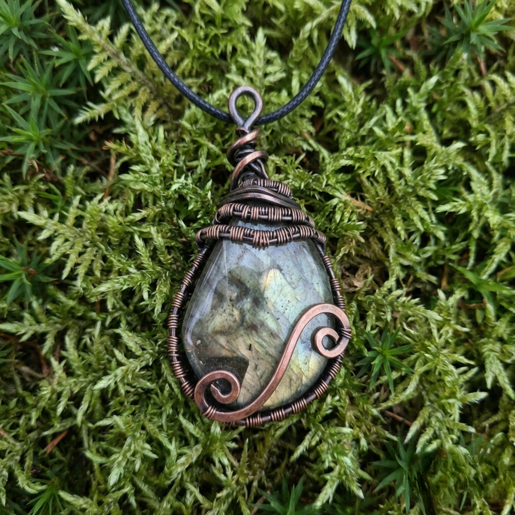 Necklace with a pendant on a green moss background