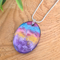 Colorful marbled pendant on a wooden surface
