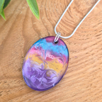 Colorful marbled pendant on a wooden surface