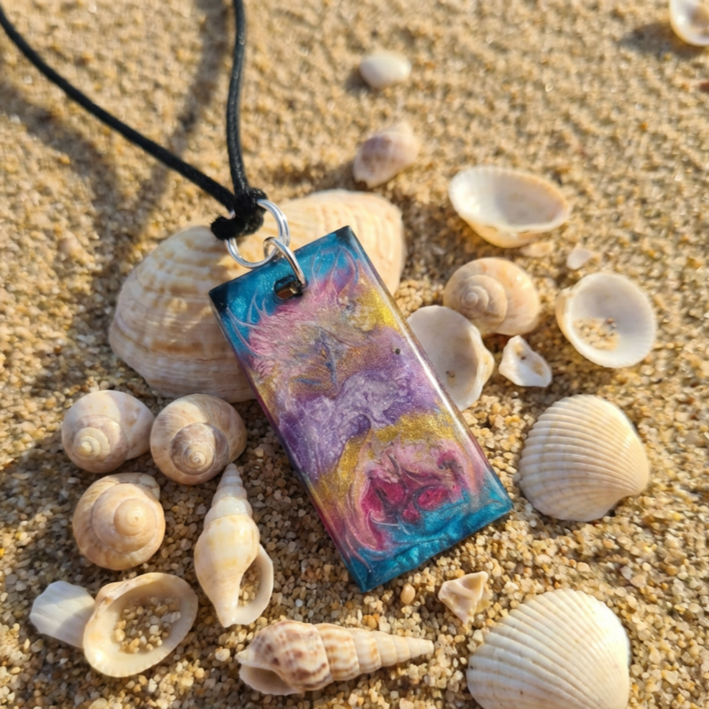 Colourful Rectangle resin pendant on the beach