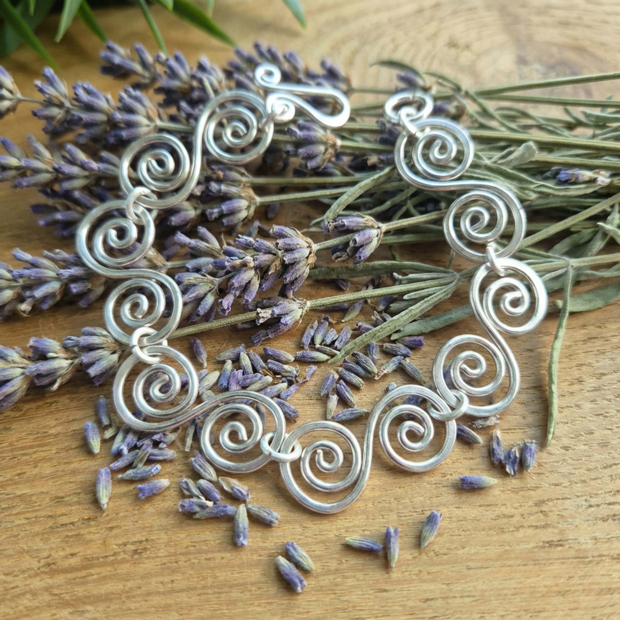 Celtic S silver spiral bracelet lying on some lavender sprigs