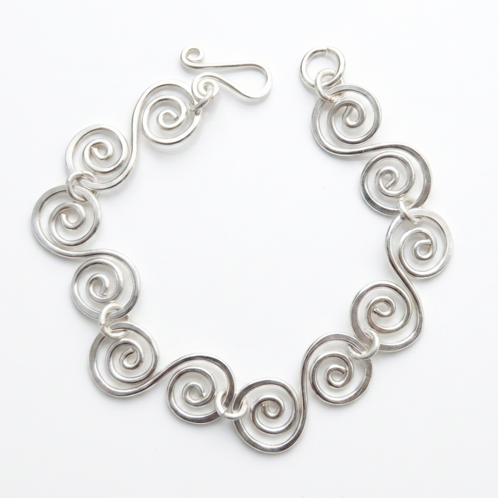 Spiral bracelet with a simple fish hook clasp on a white background