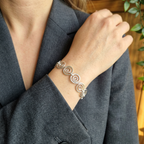 Model wearing a grey suit wearing a Celtic silver spiral bracelet