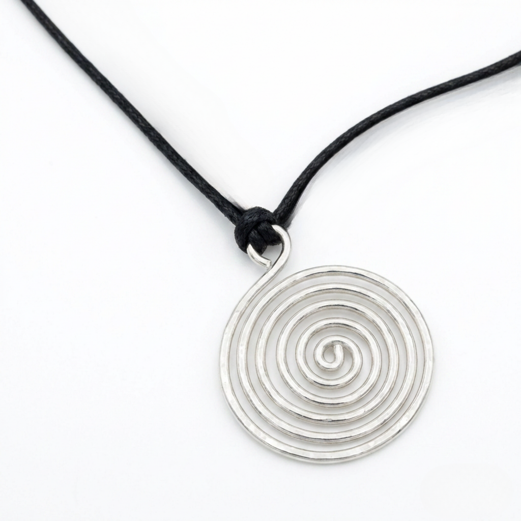 Silver spiral pendant with a black adjustable cord on a white surface