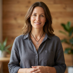Woman wearing a gray shirt with a wooden background