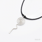 Silver spiral pendant on a black cord against a white background