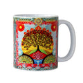 Colourful mug with a tree of life and lotus flower design on a white background