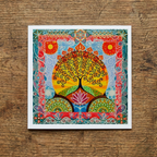 Colourful tree of life design on a wooden surface